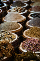 Vibrant display of colorful Arabic spices arranged in traditional bowls at a bustling market
