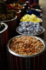 Vibrant display of colorful Arabic spices arranged in traditional bowls at a bustling market