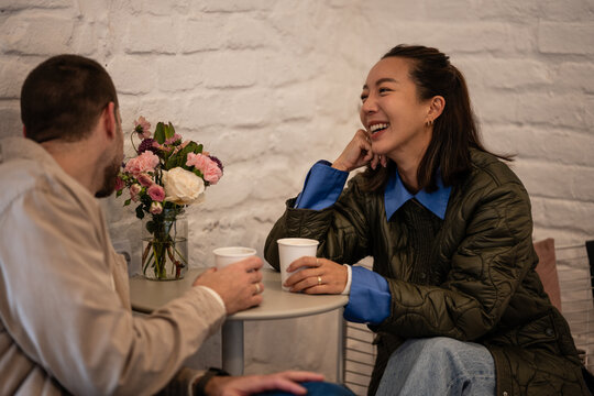 Happy couple enjoying coffee and conversation in a cafe