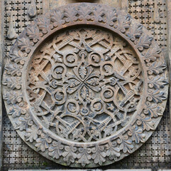 Intricately carved Armenian church stone medallion featuring traditional interlaced motifs and floral ornamentation