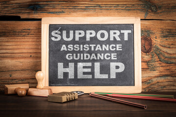 Support Concept. Chalkboard on a wooden office desk