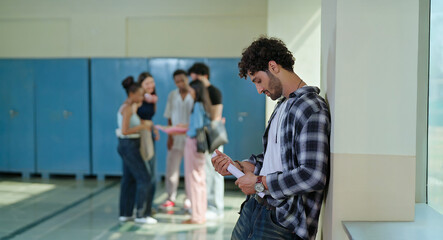 Fototapeta premium Indian sad young adult gen z man guy feel low look upset hold result paper report card fail in study exam at campus place alone lost male boy suffer fear social bully bad hostel life