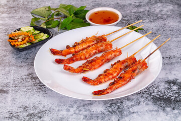 Grilled prawn skewer served sauce