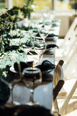 Elegant festive table setting with green decor and glassware