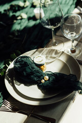 Elegant festive table setting with green decor and glassware