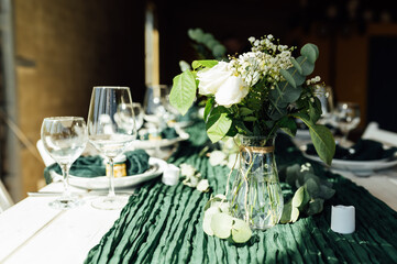 Elegant festive table setting with green decor and glassware