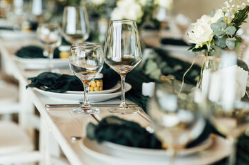 Elegant festive table setting with green decor and glassware