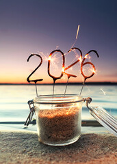 beginning of the new year 2026 with awesome sparklers firework at the beach	
