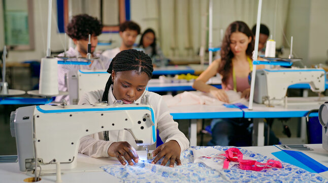 African young adult gen z lady female wear tape around neck indoor class room learn good sewing machine happy teen girl pupil do casual self craft skill new college day place