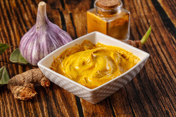 Obraz premium Indian yellow spicy curry sauce