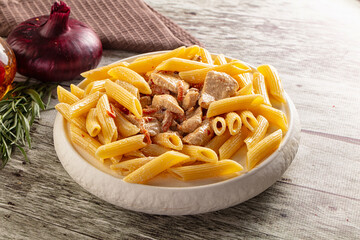 Pasta penne with chicken in cream sauce