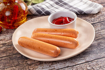 Boiled sausages with ketchup