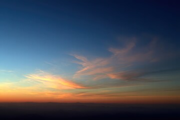 Fototapeta premium Blue to orange sunset sky gradient over a calm horizon