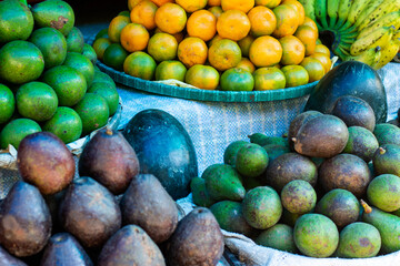 Vegetable seller displaying fresh local produce and fruits at a vibrant Kalimpong market, India