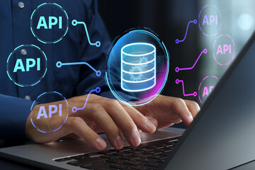 API automation technologies. Workflow integration and data exchange for cloud servers. Businessperson using laptop computer.