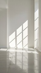 Sunlight streaming through window creating geometric shadows on white wall and floor.