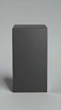 Slow top-to-front tilt revealing a sleek, matte black product box on a gray background, ideal for packaging mockup, design, and branding.
