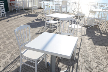 White furniture on terrace by sea on sunny day. Tourism and recreation, Europe. Nature and architecture of Italy. Design backdrop.