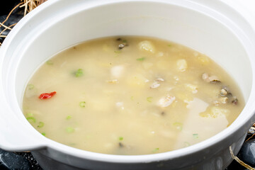 Potato and seafood soup in a white porcelain bowl