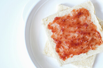 Close-up of white bread with raspberry jam