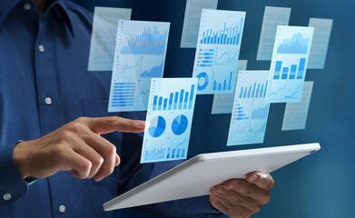 Business reports. Document with charts and graphs. Document management system. Businessperson using tablet computer.