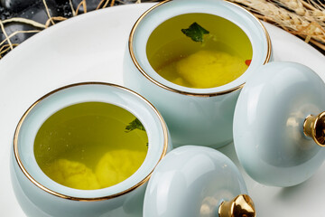The nourishing soup served in exquisite tableware