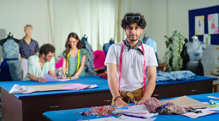 Indian young adult gen z man wear tape around neck learn new craft course look camera class room....