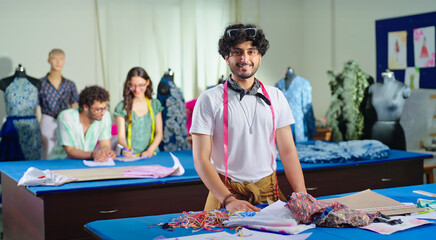 Indian young adult gen z man wear tape around neck learn new craft course look camera class room....