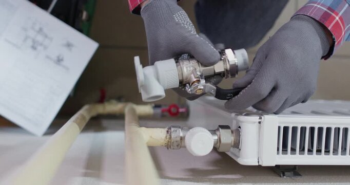 Technician twists adapter onto valve nipple keeping pitch aligned. Plumber tightens joint by hand and performs seal test while inspecting connection upper view