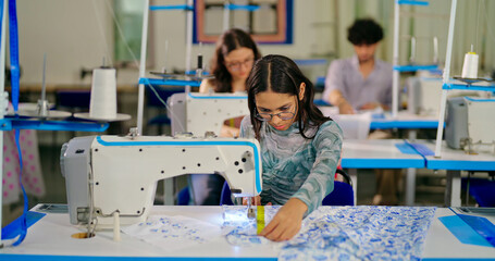 Indian young adult pupil gen z woman wear glasses tape around neck sitting class room learn new...