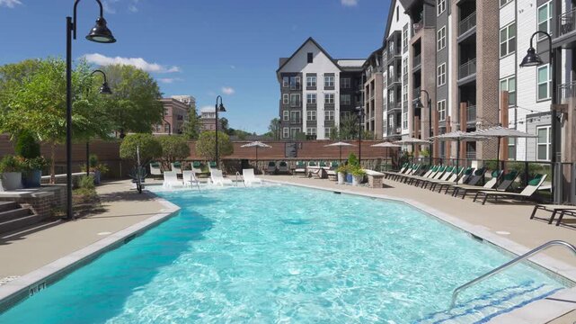 Luxury apartment complex swimming pool on a bright sunny day