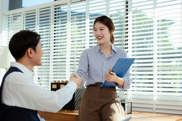 Business men and women shake hands confidently professional investor working with new startup project at an office meeting.