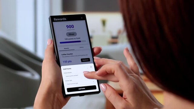 Businesswoman Holds Phone Showing Loyalty Points App