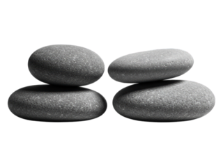 Four smooth grey stones stacked evenly on a black background