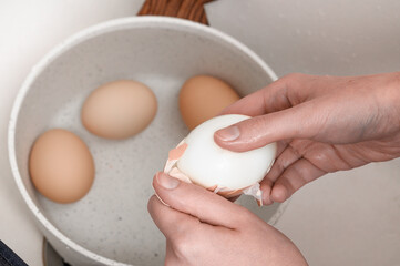 Close-up of a chicken egg being peeled from the shell