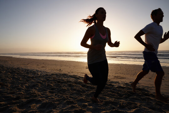 Exercise, running and sunset with couple on beach together for cardio training or workout. Fitness, mockup space and summer with athlete or runner people outdoor on coast for health or wellness