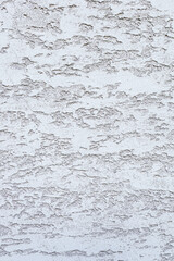 Textured white wall with a rough surface. The wall features a subtle pattern, creating a visually interesting backdrop for various applications.