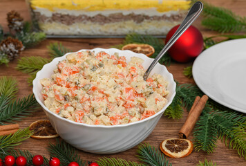 Christmas vegetable salad, cooked vegetables with mayonnaise in a salad bowl on the table