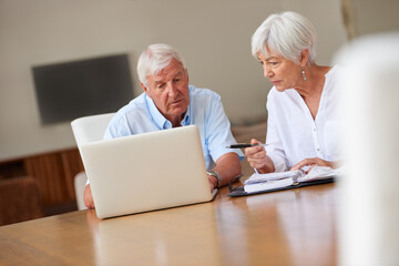 Old couple, talking and laptop in home with paperwork, utility bills review and financial planning. Married, elderly people and computer with documents for household costs, budget and communication.