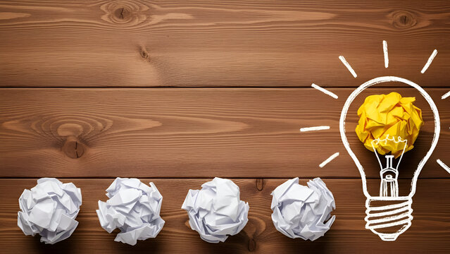 Unleash Your Creativity Bright yellow crumpled paper bulb inspires innovation near discarded ideas on rustic wood - perfect for brainstorming concepts - Powered by Adobe