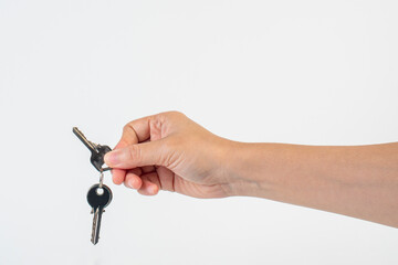 Key with a ring in hand on a white background.