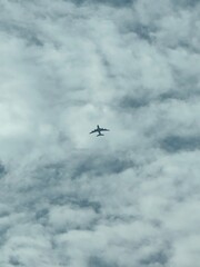 Airplane Silhouette Flying Above the Clouds