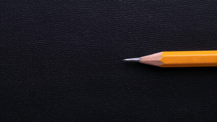 close-up of yellow pencil on black background
