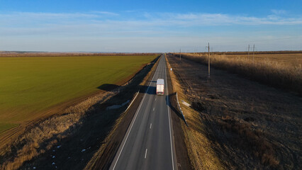 Fototapeta premium trucks carrying cars are driving on the highway in early spring