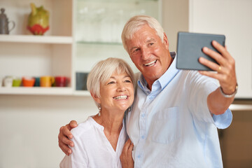 Selfie, happy and senior couple hug in home for memory, profile picture and bonding in kitchen. Retirement, marriage and elderly man and woman with embrace for photo, social media and smile for love