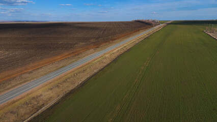 trucks carrying cars are driving on the highway in early spring