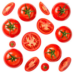 Fresh tomatoes whole, halved, and sliced on a stark dark background