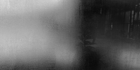 Abstract black and white background texture resembling blurred frosted glass with heavy digital...