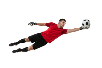 Soccer goalkeeper diving to catch ball in mid air on isolated background, athletic male making save with gloves and focused expression for sport training, competition and team defense concepts