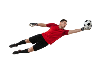 Soccer goalkeeper diving to catch ball in mid air on isolated background, athletic male making save with gloves and focused expression for sport training, competition and team defense concepts